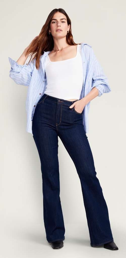 A model in a white bodysuit paired with slim fit dark wash jeans.