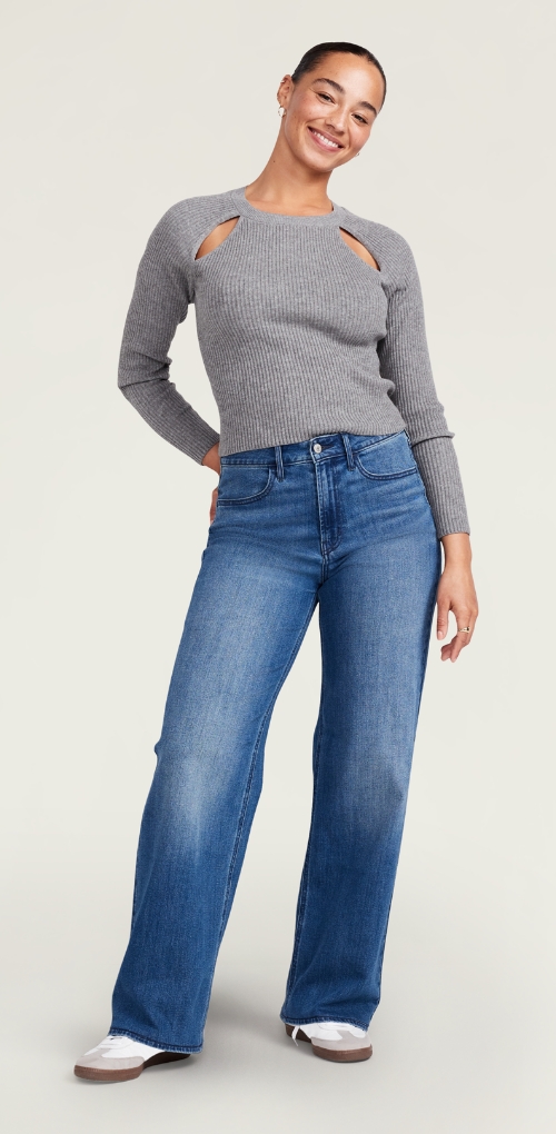 A female wearing wow wide leg jean and long sleeve rib knit top.