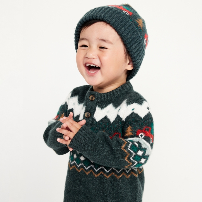 A baby boy wearing sosoft crew-neck sweater and matching beanie.