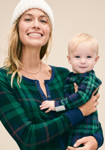 A mother and baby wearing family matching pajamas.