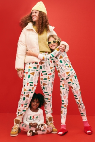 Female family members wearing matching holiday-themed pajamas