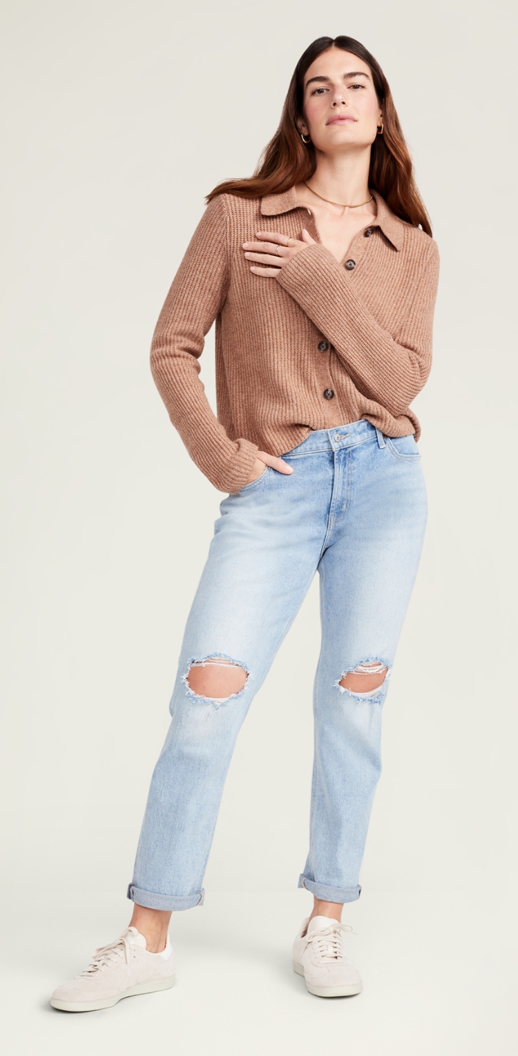 A pair of light wash ripped jeans with the ankle cuffed.