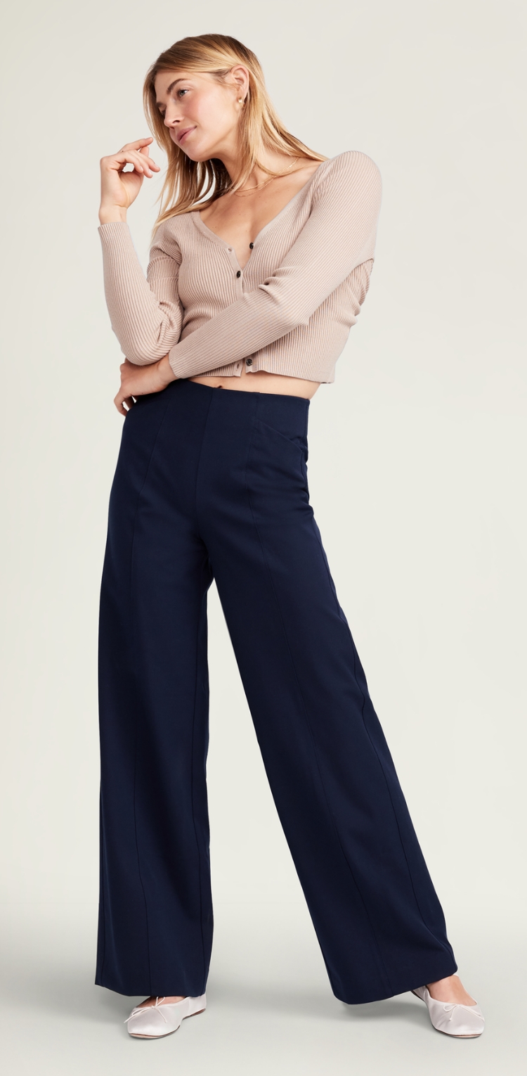 A stretchy dark high waist pant with wide leg room.