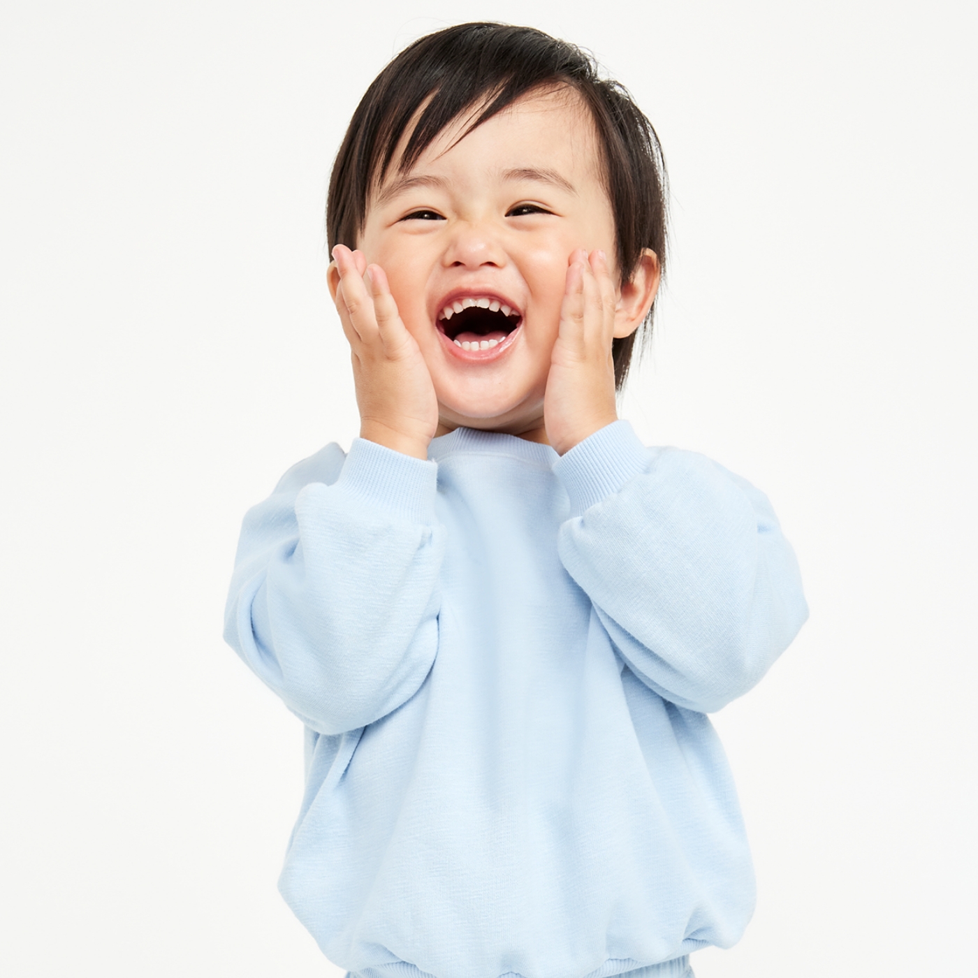 A baby boy wearing sosoft crew-neck sweater and matching joggers.