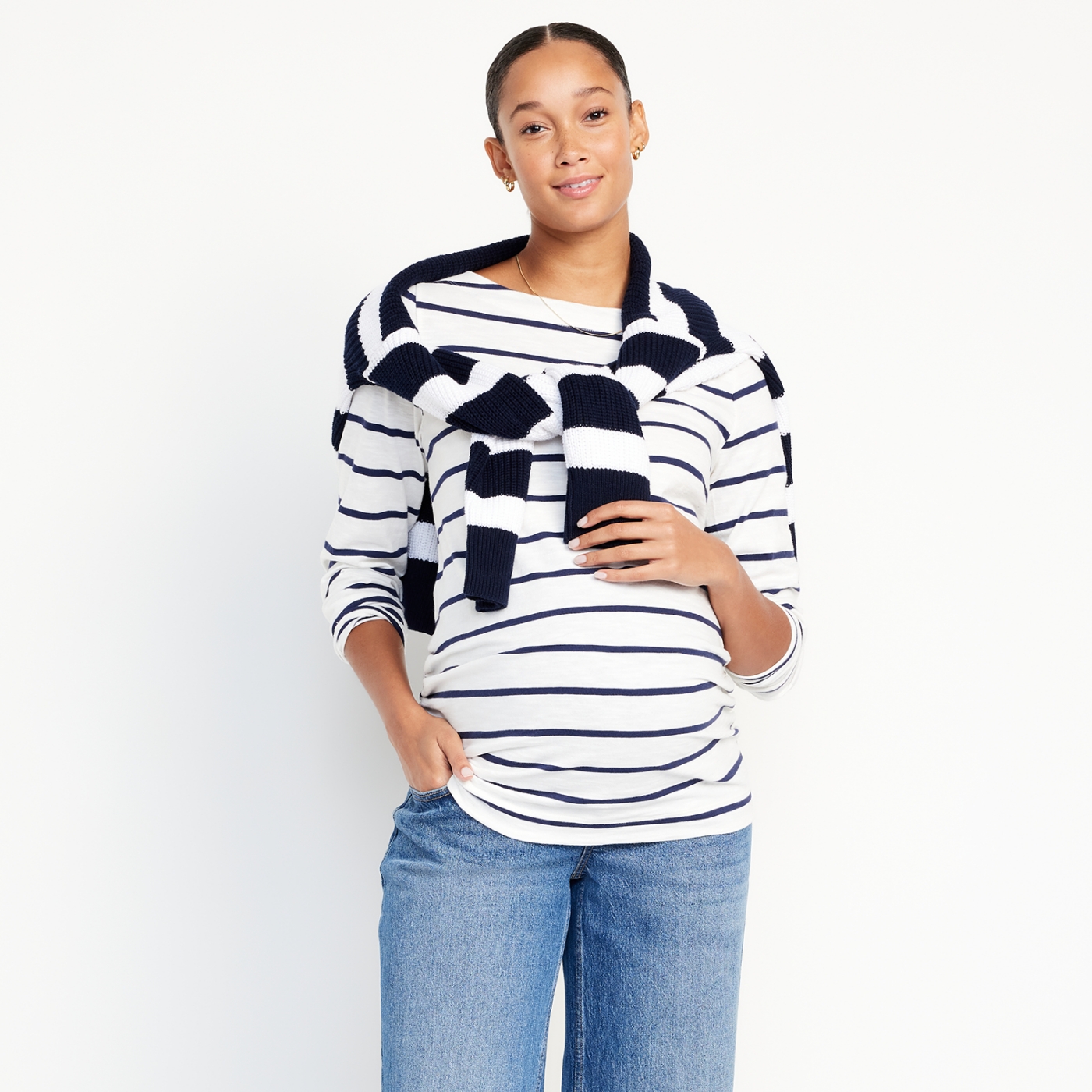 A maternity model dressed in jeans and a striped top.
