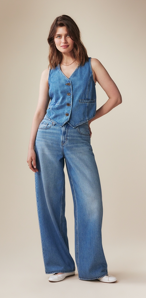 A pair of mid-rise medium washed baggy wide leg jeans.