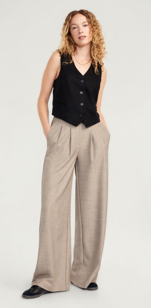 A female model wearing polished super wide leg pants.