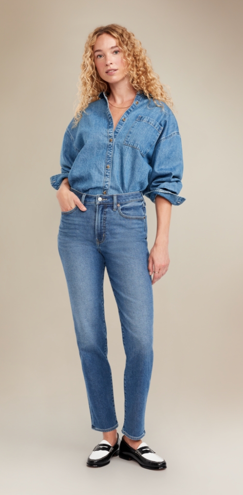 A female model wearing brushback straight jeans and denim shirt.