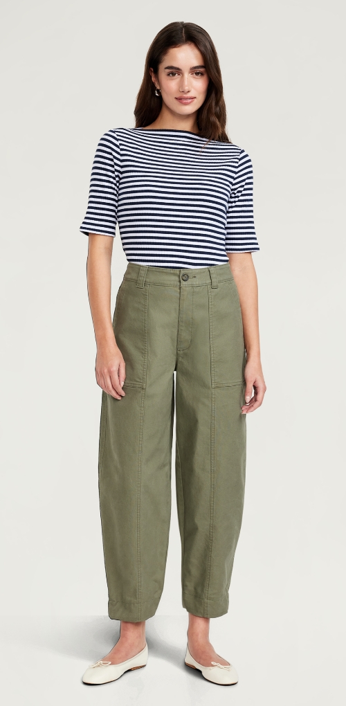 A woman dressed in barrel leg olive green pants.